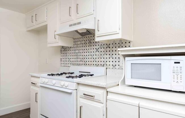 a stove top oven sitting inside of a kitchen