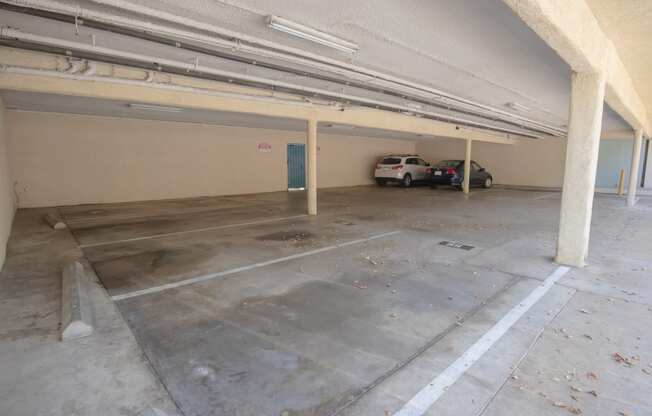 a parking garage with two cars in it