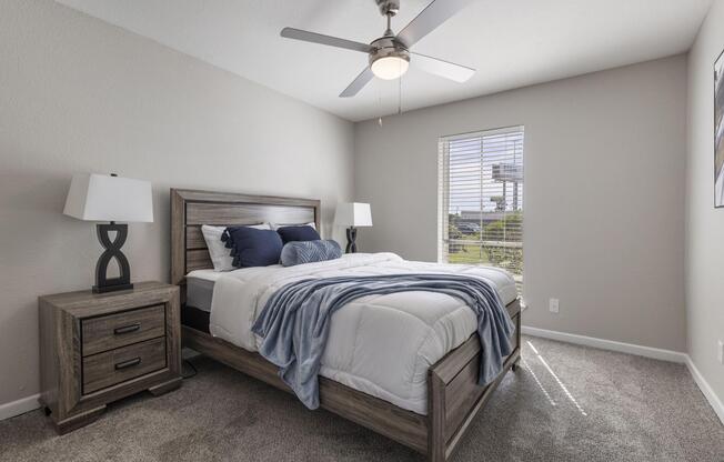 a bedroom with a bed and desk in a room