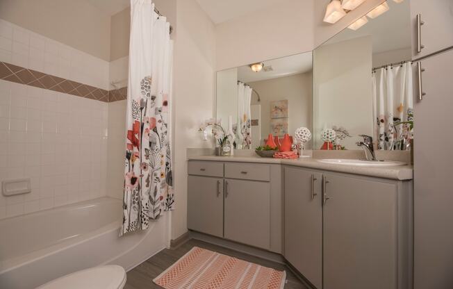 a bathroom with a shower and a sink and a toilet