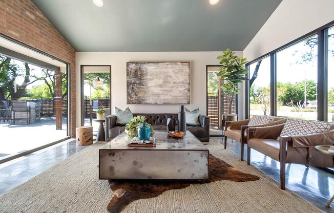 a living room filled with furniture and a large window