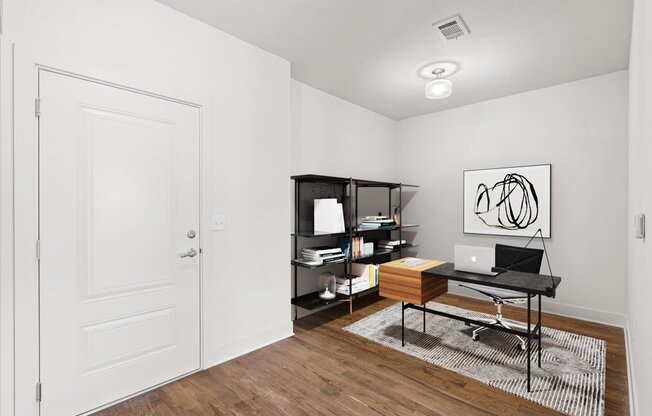 a room with a desk and a bookshelf