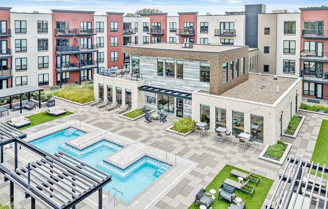 A large building with a pool in the middle of a courtyard.