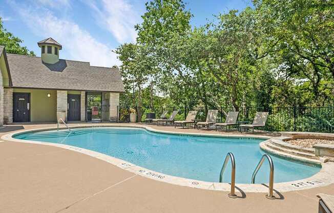 A pool with a small building next to it.