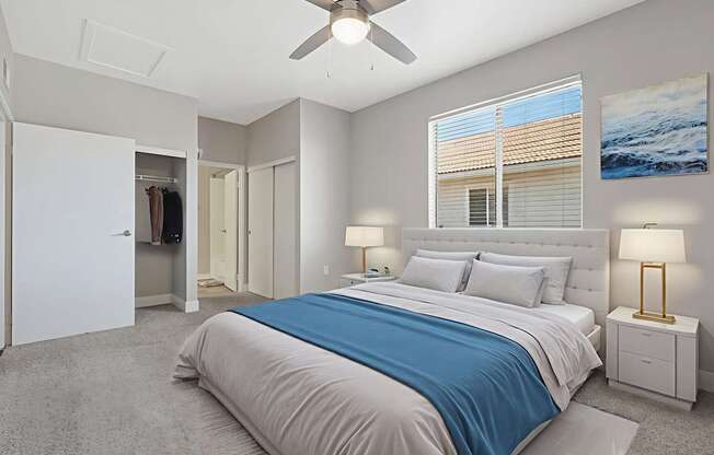 A bedroom with a large bed and a ceiling fan.