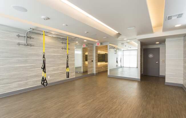 a large room with wood floors and white walls