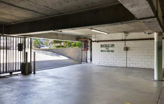 the inside of a parking garage with a gate at Camino de Oro Apartments, Torrance, CA, 90505