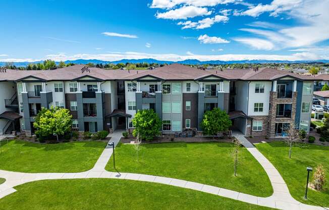 an aerial view of an apartment building with green grass and trees at Arbour Commons, Colorado, 80023