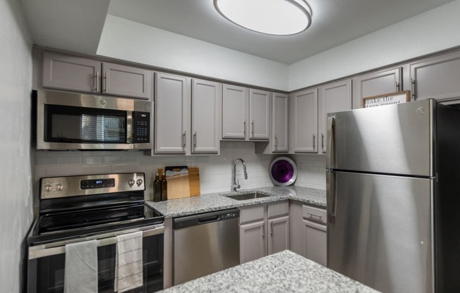 a kitchen with stainless steel appliances and granite counter tops