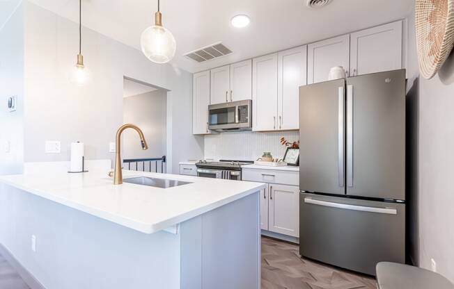 white kitchen with stainless steel appliances