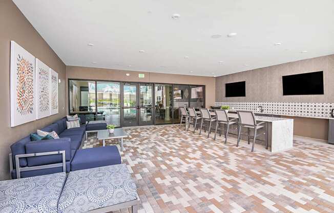 Lounge area with TVs and a bar at The Foundry Luxury Apartments in Tampa FL
