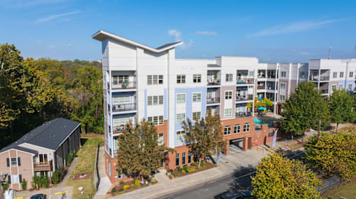 A modern apartment complex with a mix of brick and white buildings.