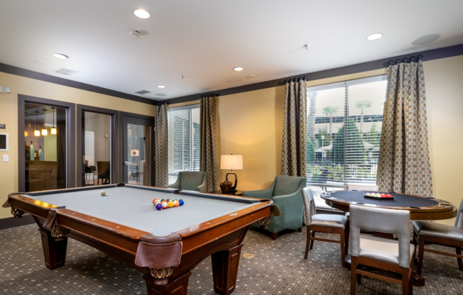 Resident game room with pool table and other activities at Orlando apartments for rent