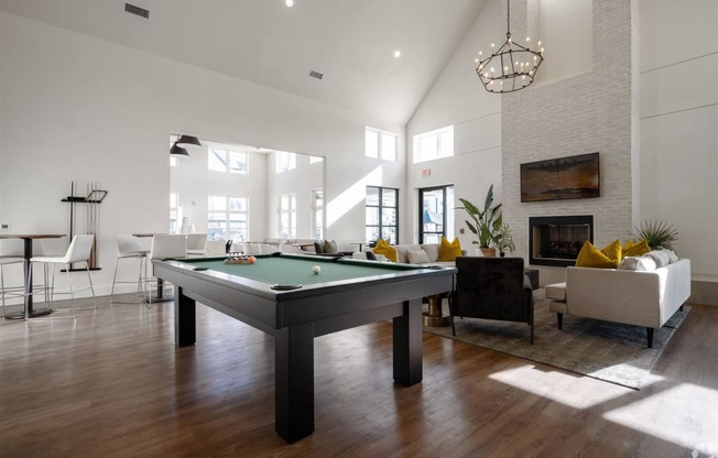 an open living room with a pool table at The Fitzroy San Marcos, San Marcos