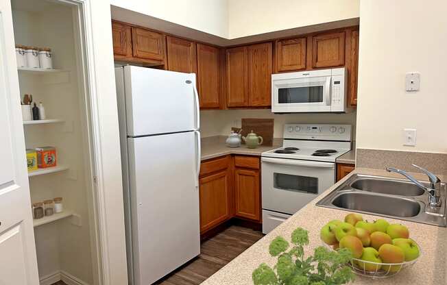 Liberty Landing Apartments Heathrow Floor Plan Kitchen with pantry, refrigerator, stove and sink. West Jordan, Utah.