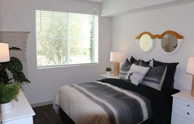 a bedroom with a bed and a window