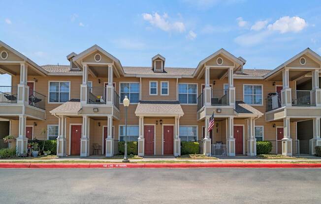 A row of townhouses with a clear blue sky above them.