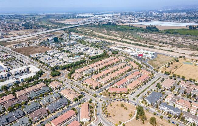 an aerial view of an urban area with buildings and roads at The Vines at Riverpark, LLC, Oxnard, CA