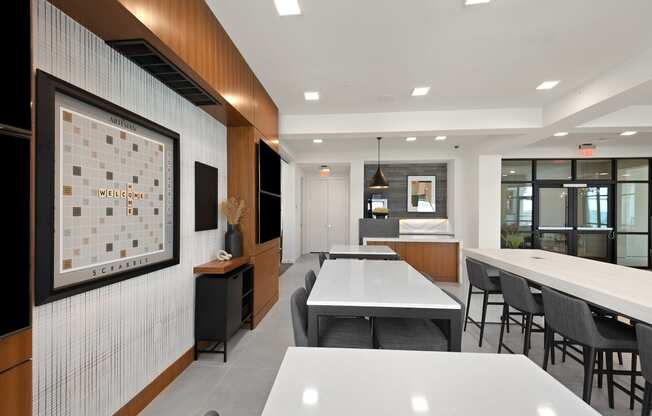 a communal area with tables and chairs and a bulletin board