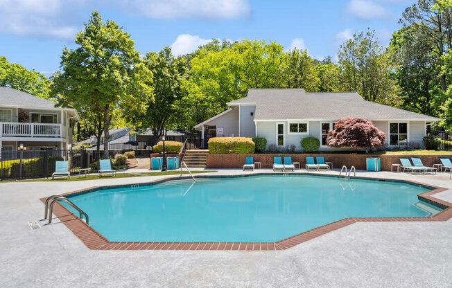 Community Swimming Pool with Pool Furniture at Dunwoody Village Apartments in Atlanta, GA.