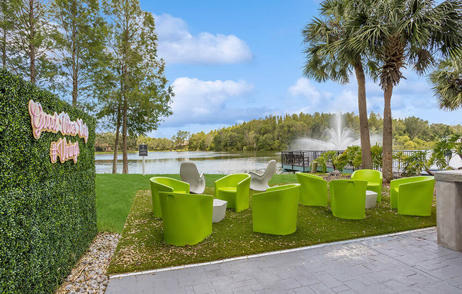 Outdoor lounge area with a fountain in the background and palm trees in the foreground