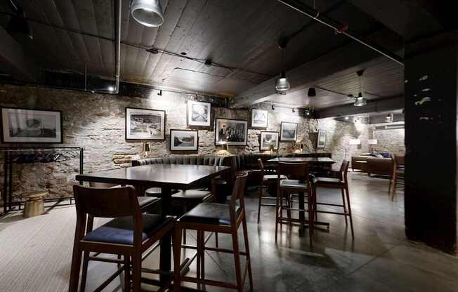 A restaurant with a long table and chairs in the center of the room.