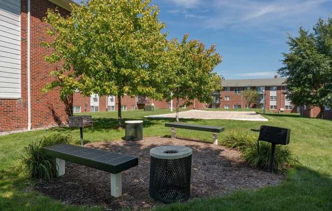 a park with benches and trees in front of a building at Village Club of Royal Oak, Michigan, 48067