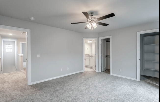 a bedroom with gray walls and a ceiling fan