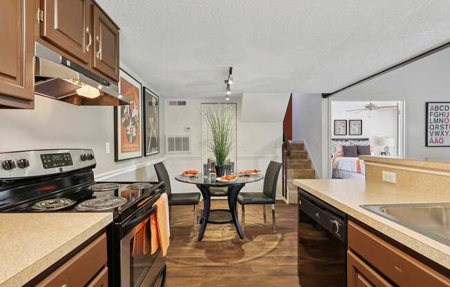 A kitchen with brown cabinets and a black stove top oven.