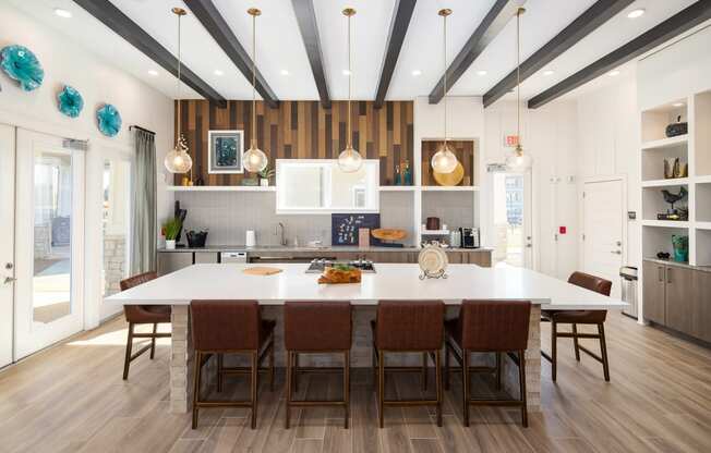 Madison communal kitchen with bar-style seating and wood-designed flooring at The Alexandria