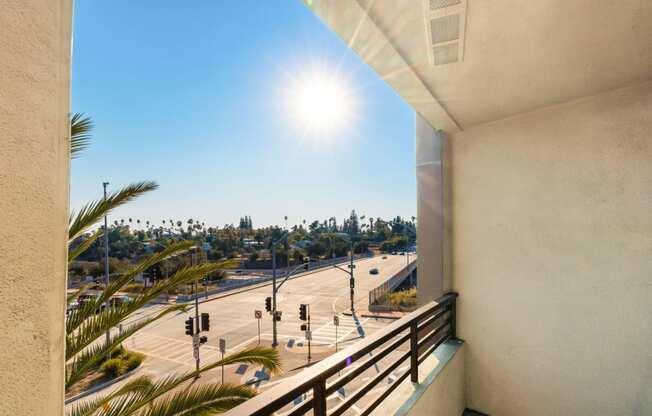 a balcony with a view of the freeway and palm trees