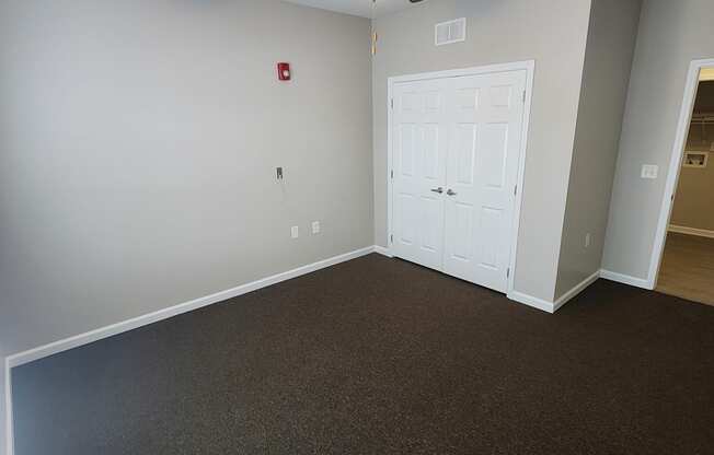 Spacious LiVing Room Area with Ceiling Fan and Closet at The Assembly Apartments, SC 29611,