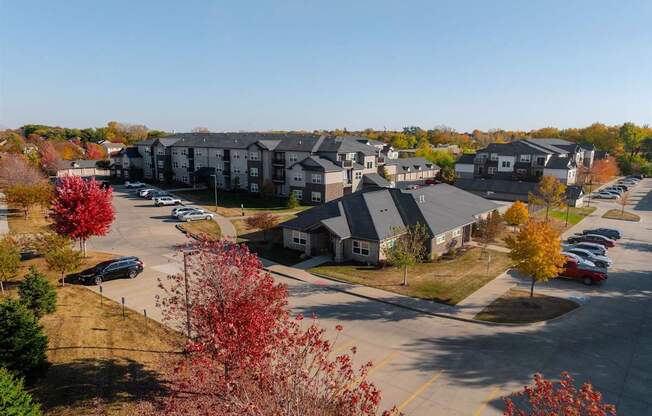 A parking lot with cars and apartment buildings in the background.