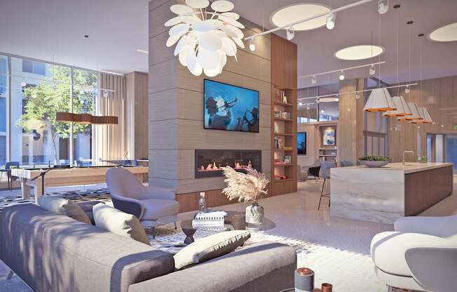 A modern living room with a grey sofa, a fireplace, and a large painting on the wall.