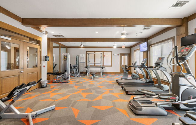 a gym with treadmills and other exercise equipment in a room at Lakeline East Apartments, Cedar Park, TX