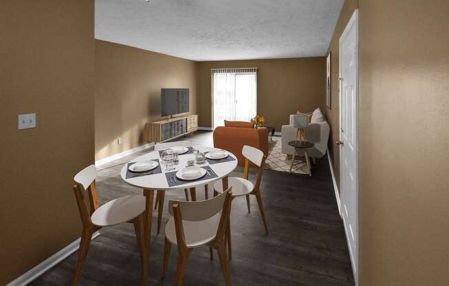 a dining area with a table and chairs and a living room in the background