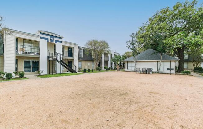 a house in the middle of a dirt field