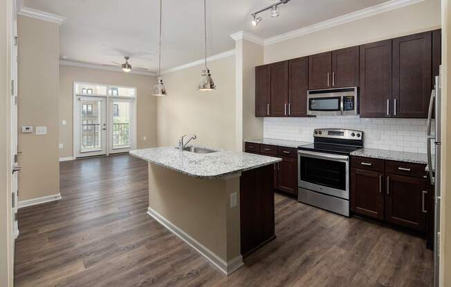 A kitchen with a white counter top and wooden cabinets.