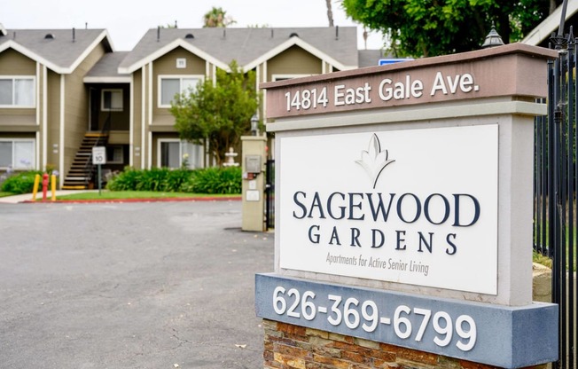 a sign in front of houses at Sagewood Gardens Senior Apartments, Hacienda Heights California
