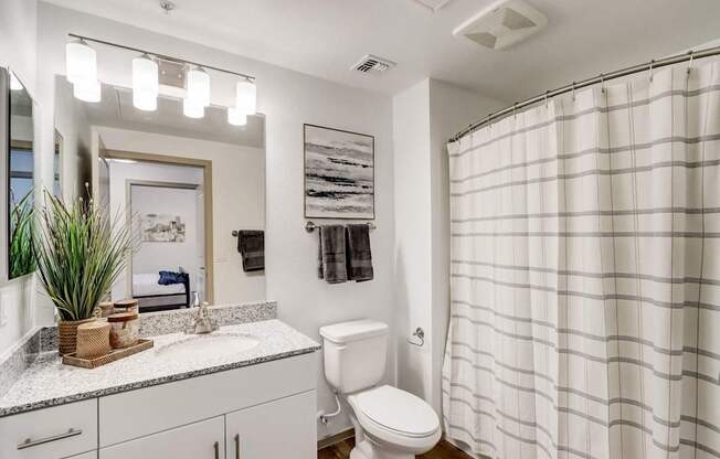 A white toilet sits next to a sink in a bathroom.