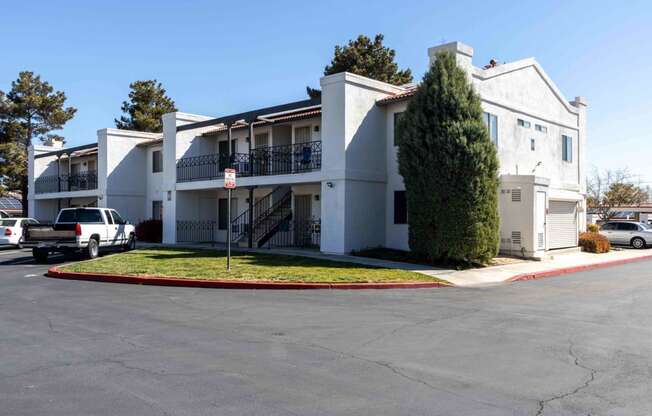 a white apartment building with a parking lot