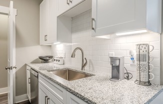 a kitchen with white cabinets and a sink