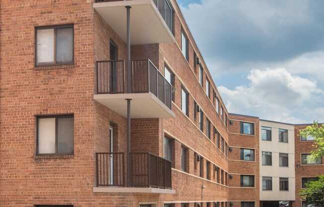 a red brick apartment building with balconies