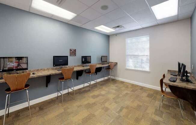 A room with a long table and chairs.