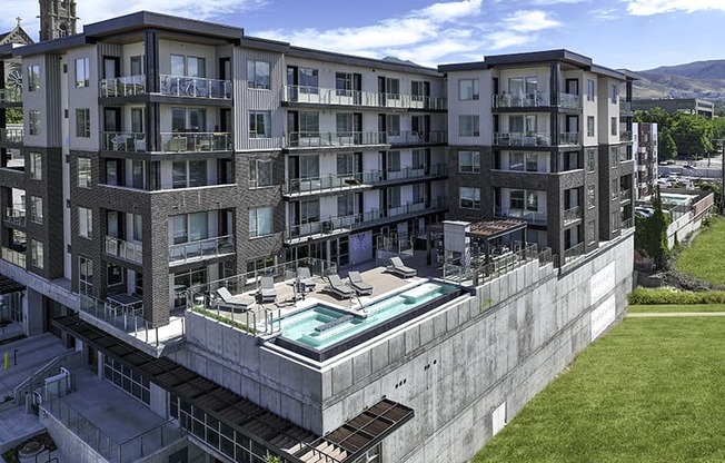 a drone shot of a pool and building at Lotus Republic Apartments for rent in Downtown Salt Lake City, Utah