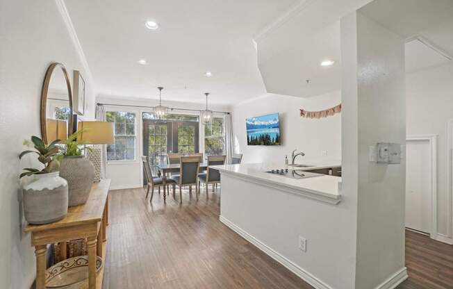 A kitchen with a dining table and chairs.