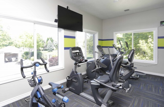 Fitness center with flat screen television and 3 stationary bikes