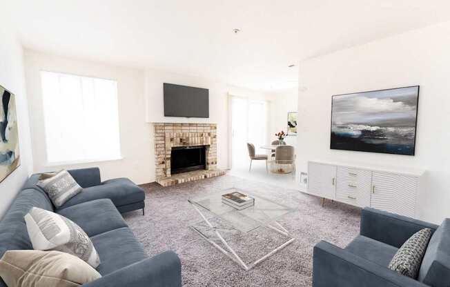 A living room with a grey sofa, a fireplace, and a television.