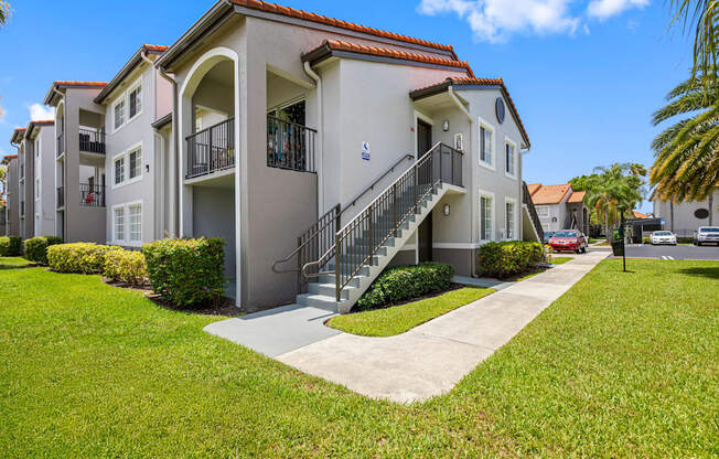 A building with a red tile roof and a balcony with a railing.