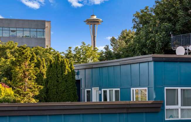 a blue building with a view of the space needle in the background at Dexter Lake Union, Seattle, Washington